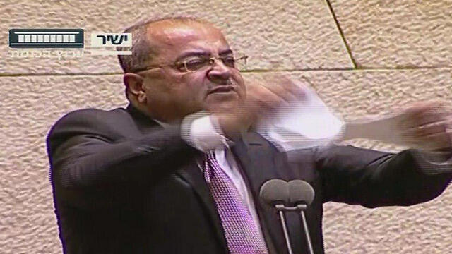 Ahmad Tibi tears up the bill from the podium (Credit: Knesset Channel)