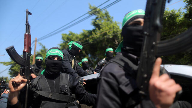 Hamas gunmen during the funeral procession (Photo: Reuters)