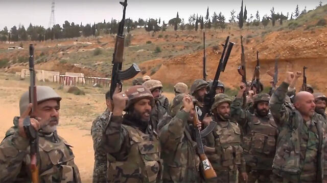 Raising their guns in salute to Assad