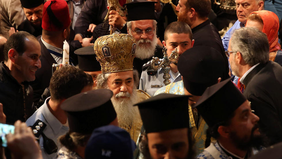 Greek Orthodox Patriarch of Jerusalem Theophilos III (C) leads the ceremony. (Photo: AFP) (Photo: AP) Greek Orthodox Patriarch of Jerusalem Theophilos III (C) leads the ceremony. (Photo: AFP)