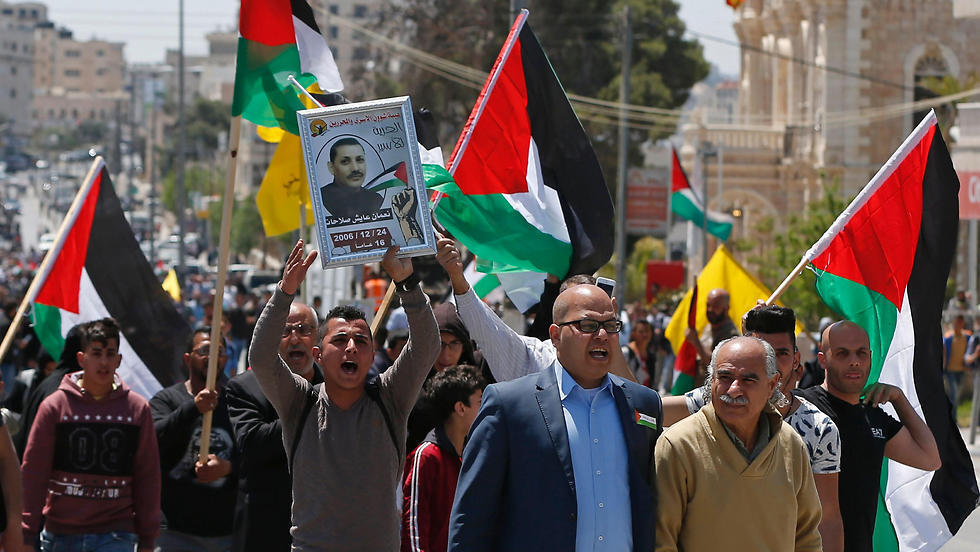 Palestinian protesters wave their national flag during a demonstration in the West Bank town of Bethlehem. (Photo: AFP)