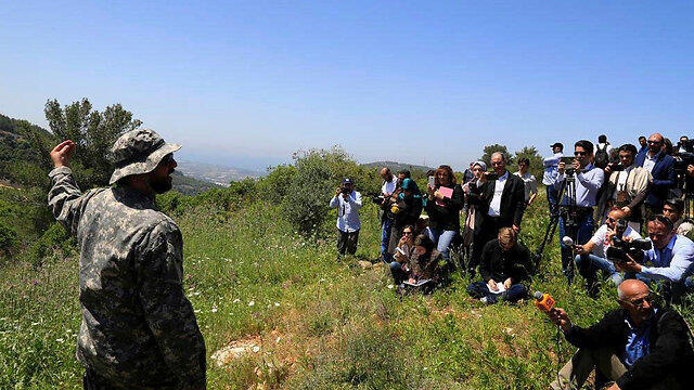 Hezbollah officer giving press a tour of the border