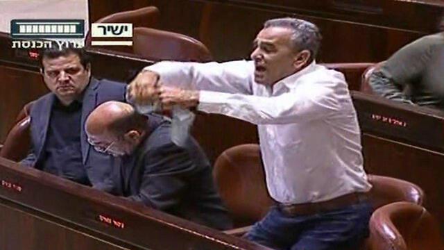 MK Zahalka tearing up the bill proposal (Photo: Knesset Channel)