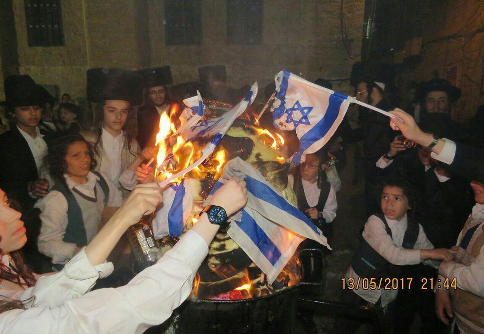 Ultra-Orthodox "Jerusalem Faction" members burning the Israeli flag in protest of the Conscription Law