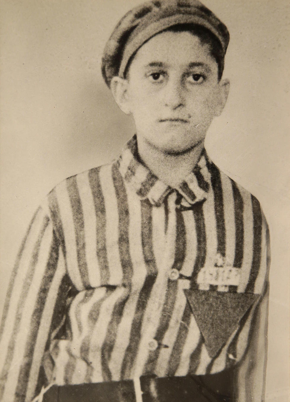 In this undated World War II-era photograph provided by Many Hats Productions, Holocaust survivor Steve Ross wears a Nazi prison camp uniform. (Photo: AP)