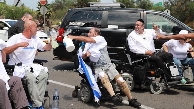 Disabled citizens dousing themselves with diesel fuel (Photo: Dana Kopel)