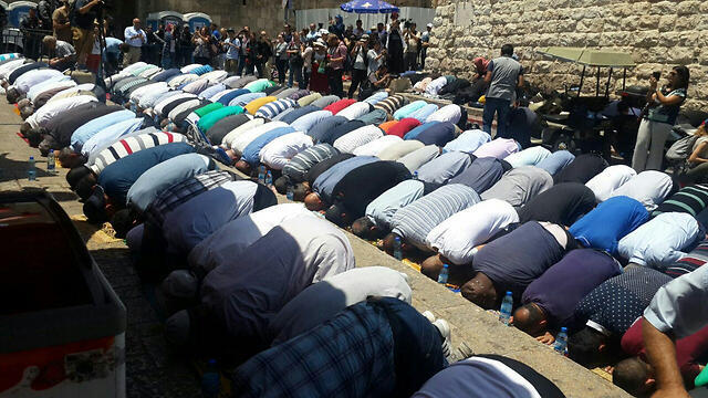Muslim worshipers pray outside the Temple Mount