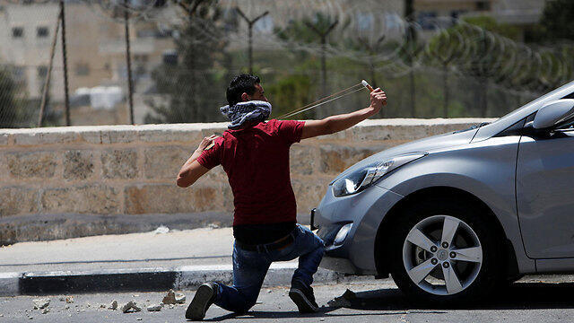 Rock thrower in Bethlehem (Photo: Reuters)