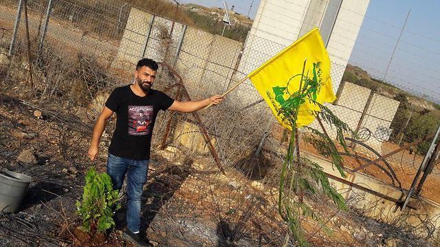 The Hezbollah standard and a newly planted tree near the Israel-Lebanon bordernullnull The Hezbollah standard and a newly planted tree near the Israel-Lebanon border