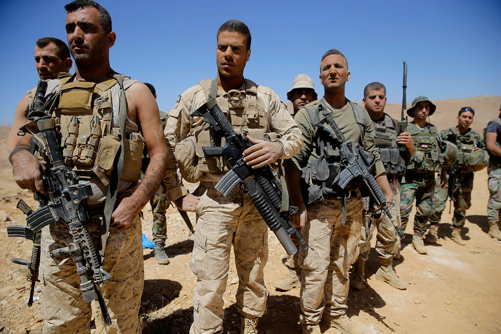 Lebanese soldiers and Hezbollah supporters celebrate Lebanon's victory over the Islamic State group near the Syria-Lebanon border, August 30, 2017 (Photo: AP) Lebanese soldiers and Hezbollah supporters celebrate Lebanon's victory over the Islamic State group near the Syria-Lebanon border, August 30, 2017