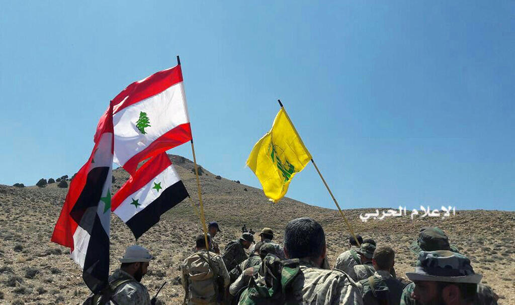 Hezbollah fighters and troops loyal to Syrian President Bashar Assad battle Islamic State insurgents near the Lebanese border, August 2017 (Photo: AP) Hezbollah fighters and troops loyal to Syrian President Bashar Assad battle Islamic State insurgents near the Lebanese border, August 2017