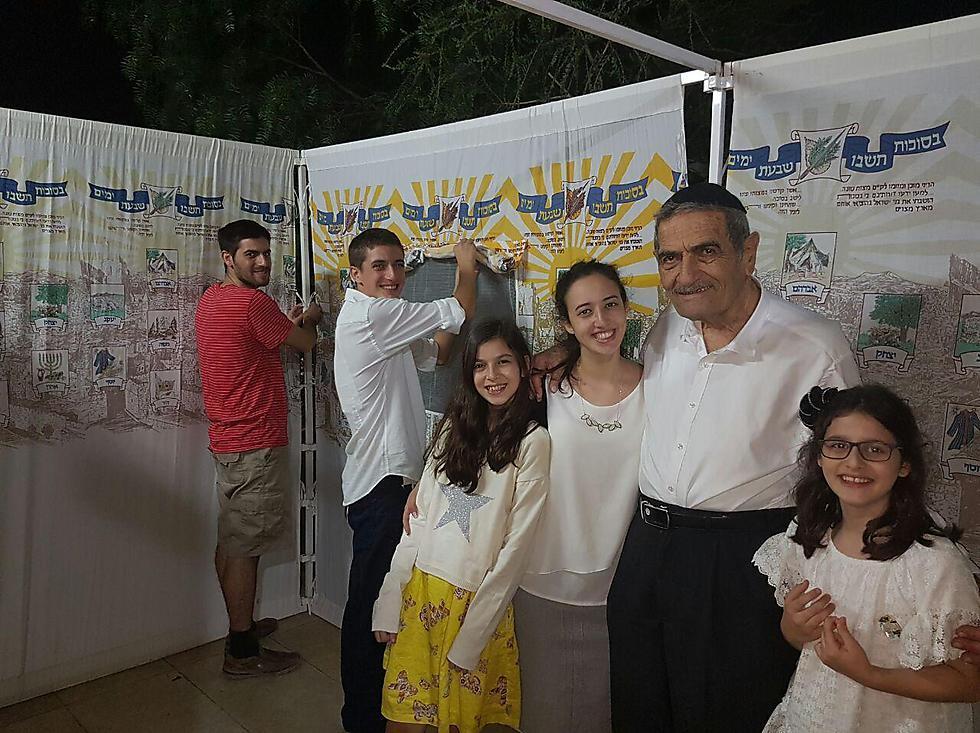 The Cohen family from Givat Shmuel are building their sukkah (Photo: Liron Nagler-Cohen)