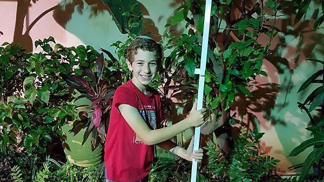 David Kfir from Givat Shmuel is hard at work on his sukkah