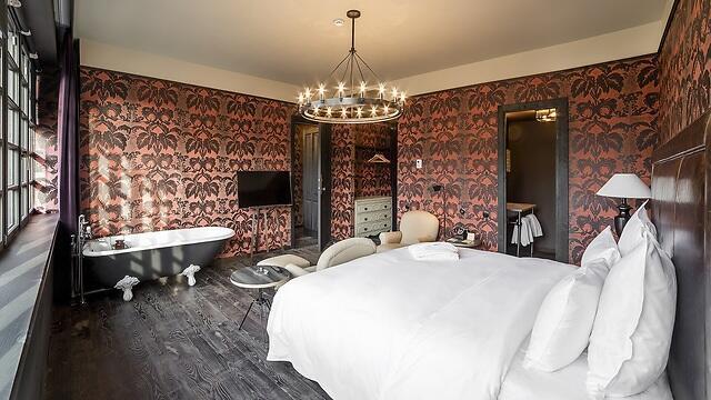 A bathtub by the bed. Vintage style