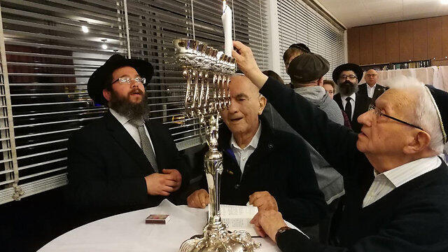 File photo: Holocaust survivors lighting Hanukkiah. Katz said he'd have no choice but to close Holocaust survivors' centers