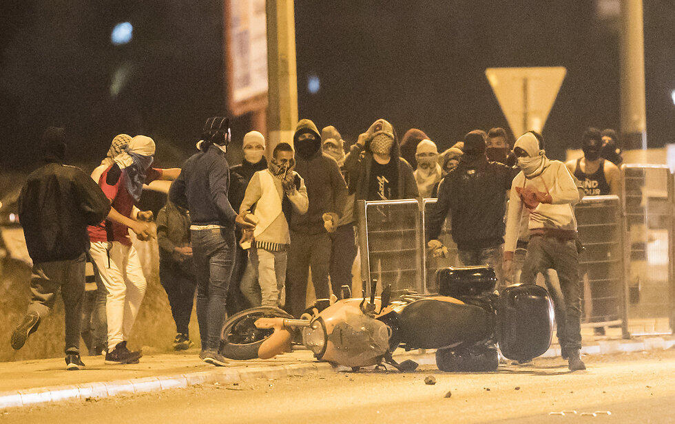 The Wadi Ara protesters standing over the destroyed bike
