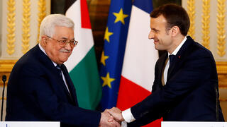 French President Emmanel Macron greets Palestinian Authority Chairman Mahmoud Abbas 