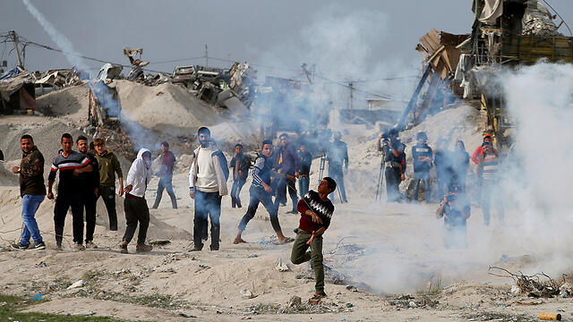 alestinian protestors clash with IDF forces near the Gaza border fence 