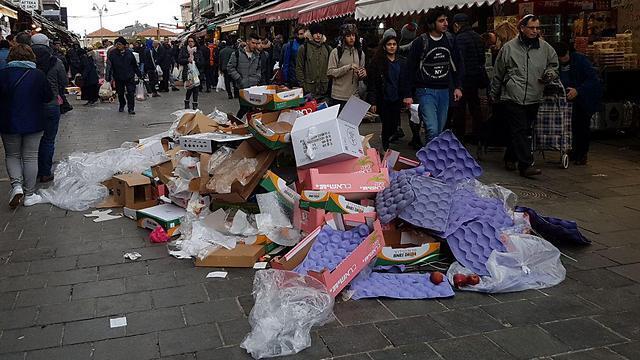 Sanitation workers piled trash in the Mahane Yehuda Market