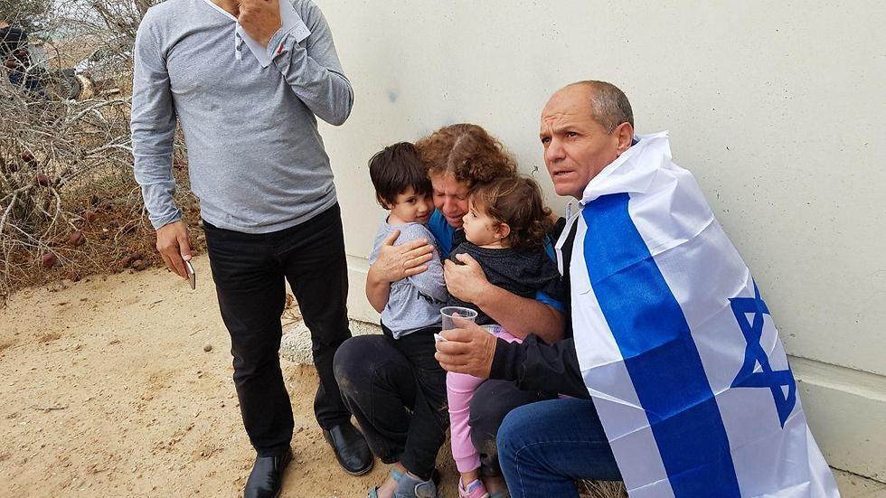 Families take cover during rocket fire on Friday