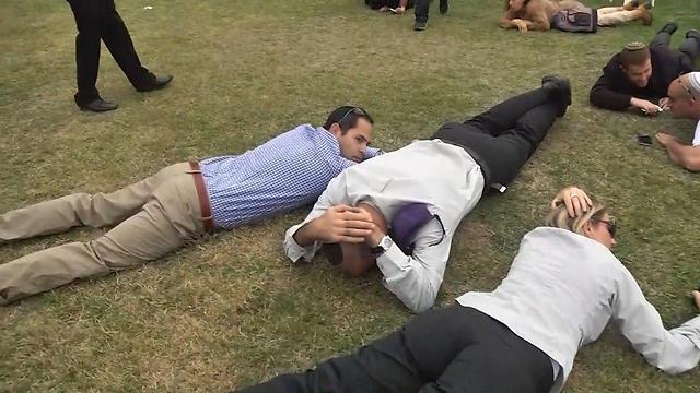 People cowering after Code Red alarm sounded in ceremony marking Oron Shaul's 24th birthday