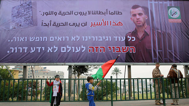 Sign in Arabic and Hebrew in Gaza: 'As long as our heroes don't have freedom.. this hostage will never know freedom.'