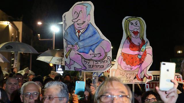 The weekly Tel Aviv protest drew some 1,500 people despite inclement weather