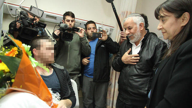 Raziel Shevah's mother (R) and father (center) speaking with the Border Policeman