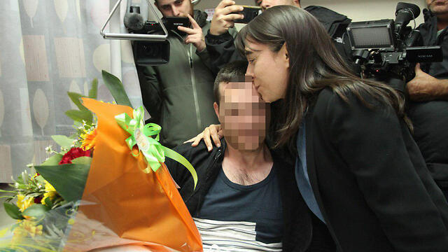 Raziel Shevah's mother (R) embarking the Border Policeman wounded in the operation to take out her son's killers