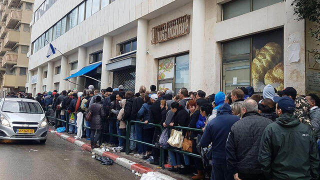 Migrants queuing outside the Population and Immigration Authority's offices to submit asylum requests