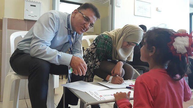 Dr. Salman Zarka, the director of the Ziv Medical Center in Safed with a young Syrian girl (צילום: דובר צה"ל) Dr. Salman Zarka, the director of the Ziv Medical Center in Safed with a young Syrian girl