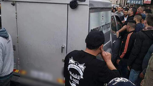 Palestinians encircle the military vehicle