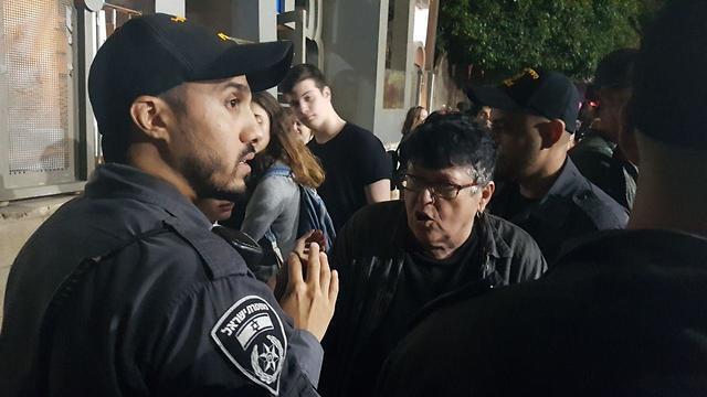 Paz, surrounded by policemen before being dragged outside the event