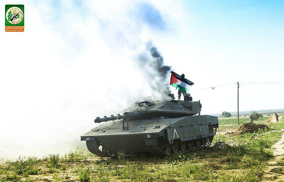 Palestinian flag atop a replica of an Israeli Merkava tank