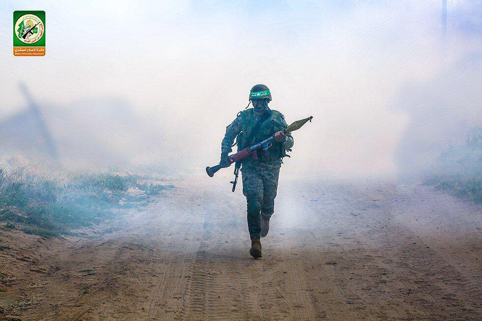 Hamas fighters charging with a rocket