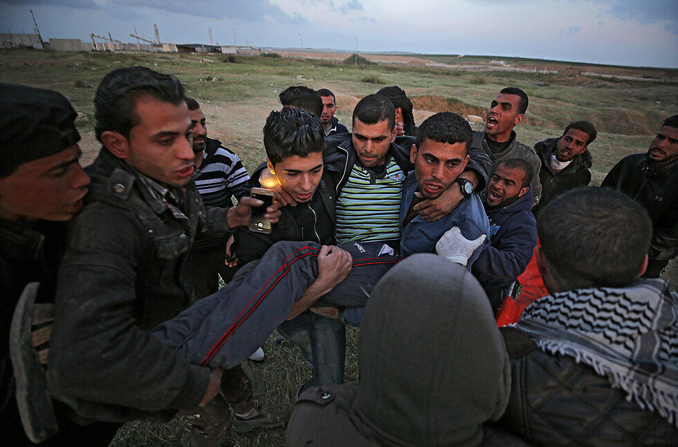 Evacuating a wounded Palestinian during Friday's clashes
