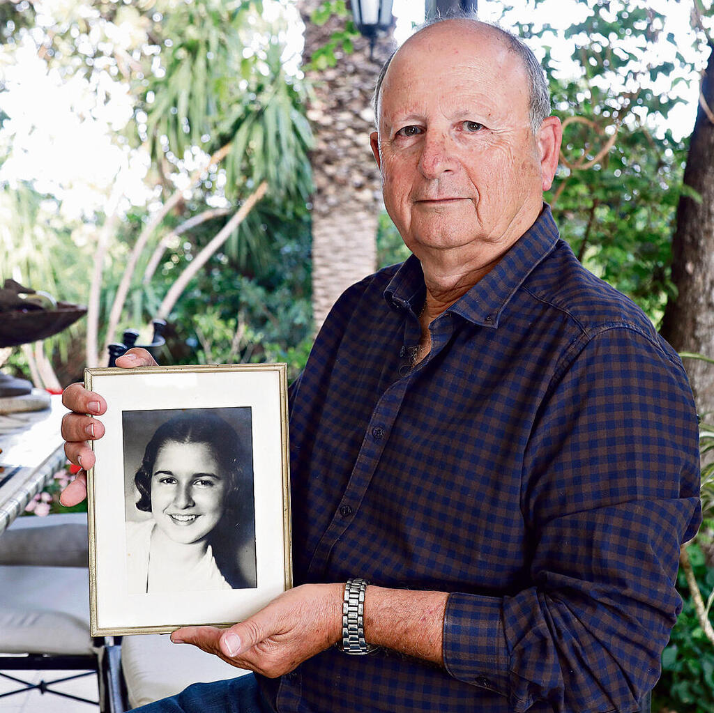 Colonel (res.) Danny Ben Ari holds a picture of his late mother