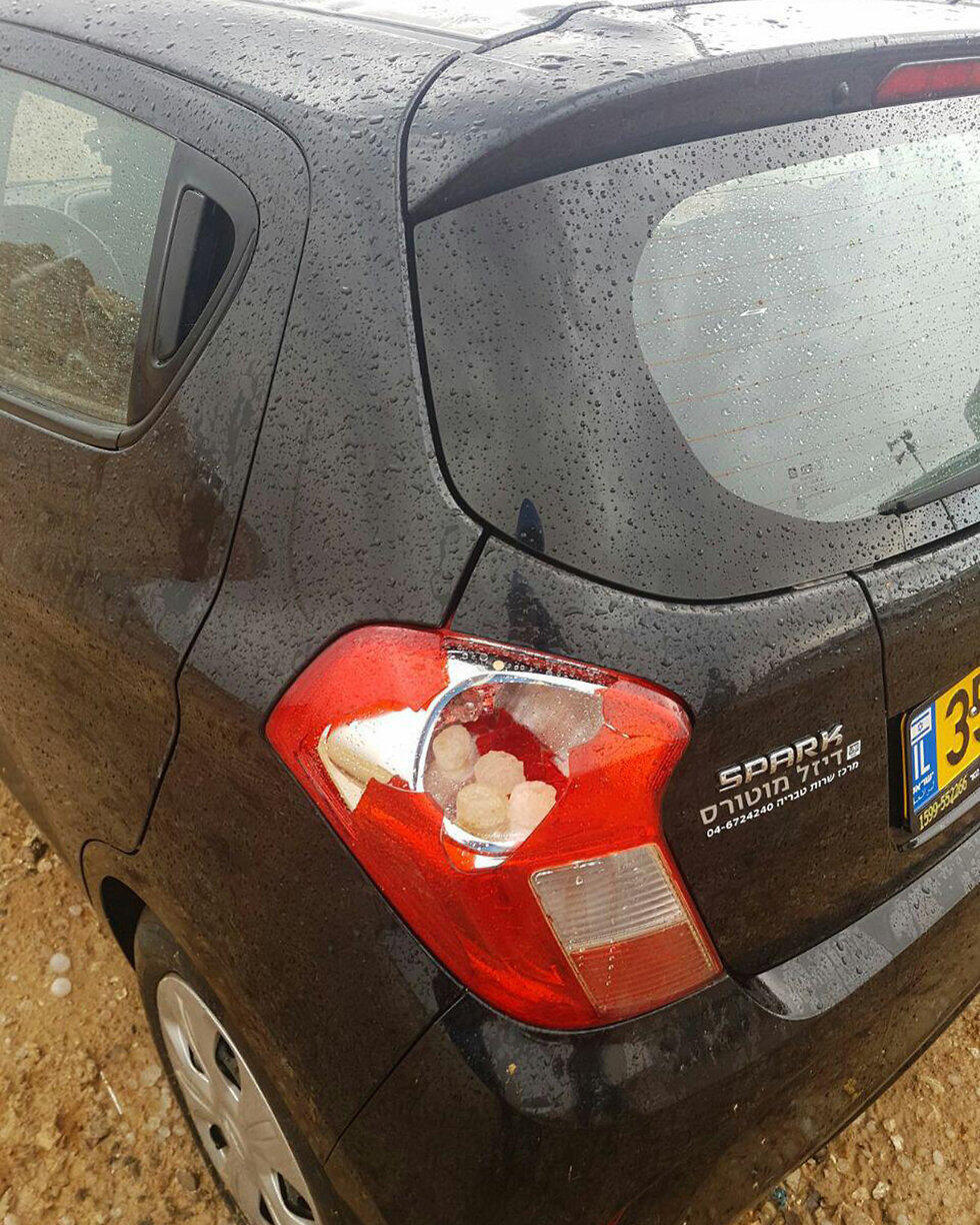 Car's tail light struck by hail in Dimona