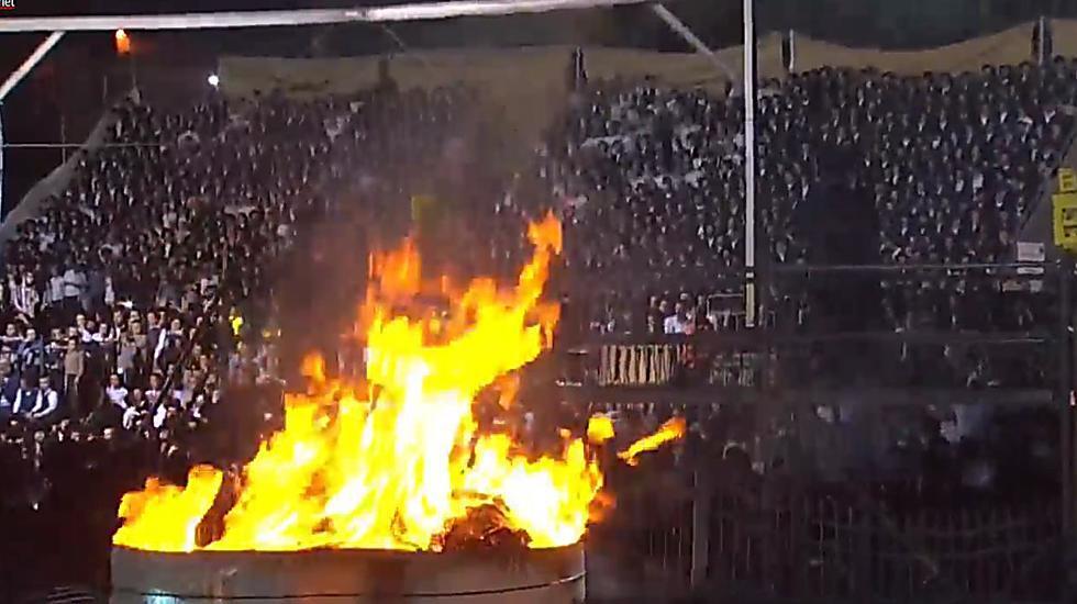 Crowds surround the giant bonfire