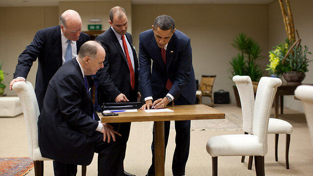Ben Rhodes standing next to Obama