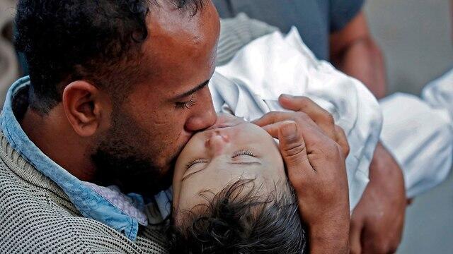 Ghandour's father holds his daughter's body 