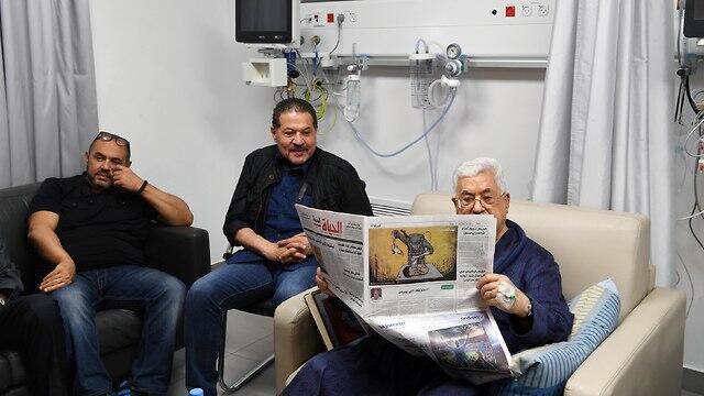 Abbas with sons Yasser and Tareq at the hospital in Ramallah in May