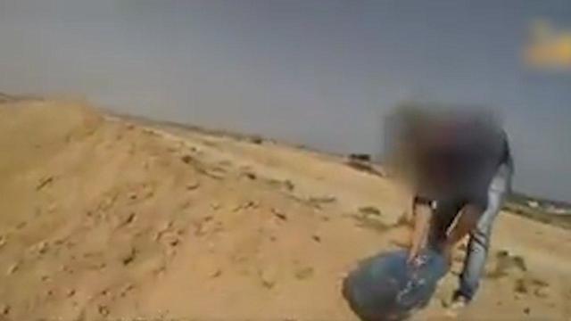 Palestinian lighting a fire, as seen in Hamas footage of infiltration