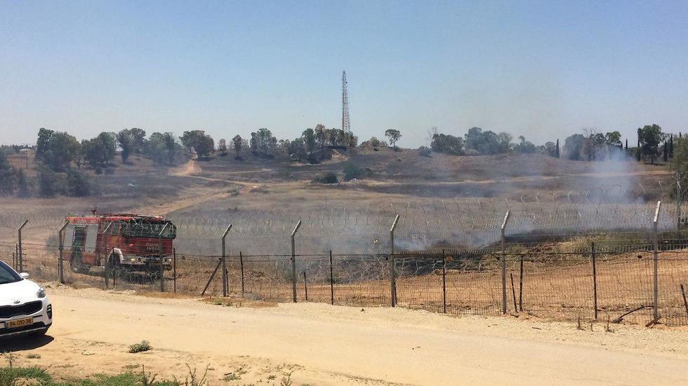 Firefighters putting out a fire started by an incendiary kite