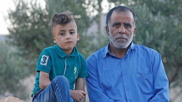 Hussein Dawabsheh with his grandson Ahmed, the only one to survive the attack (צילום: שאול גולן) Hussein Dawabsheh with his grandson Ahmed, the only one to survive the attack