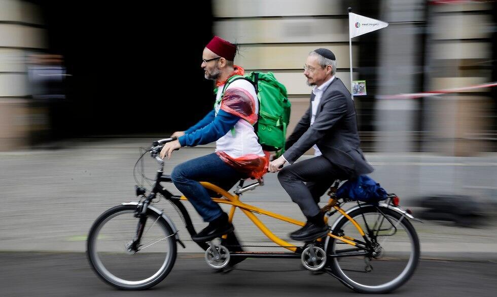 A Muslim and a Jewish man ride a tandem together during a bicycle tandem tour of Jews and Muslems against anti-Semitism and hatred of Muslims in Berlin