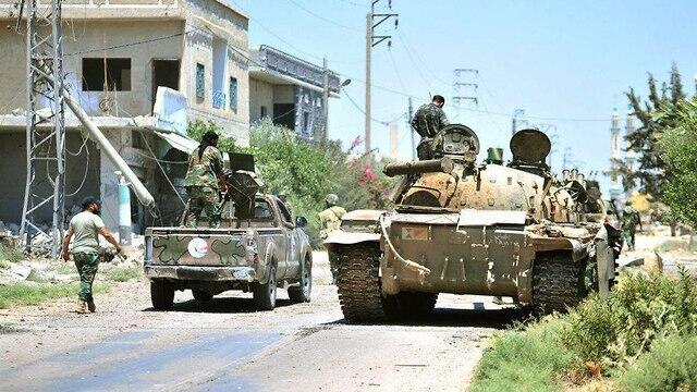 Сирийские солдаты в захваченной деревне. Фото: AFP