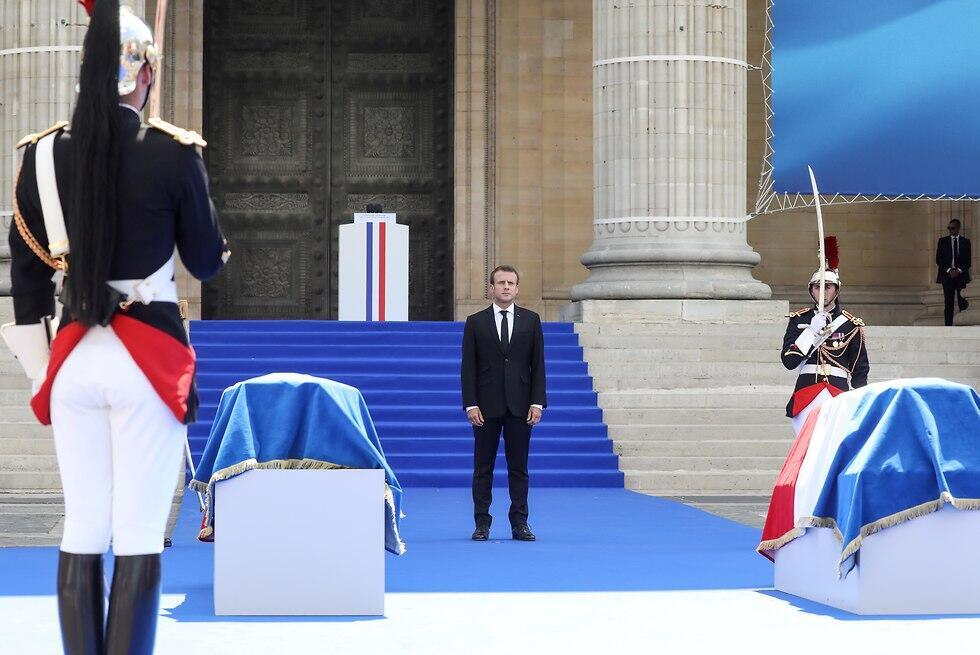 President Macron stands by the coffins