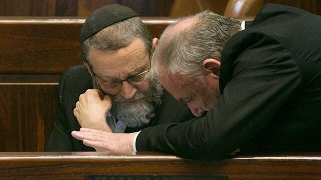 Coalition chairman David Amsalem, right, talks to UTJ MK Moshe Gafni