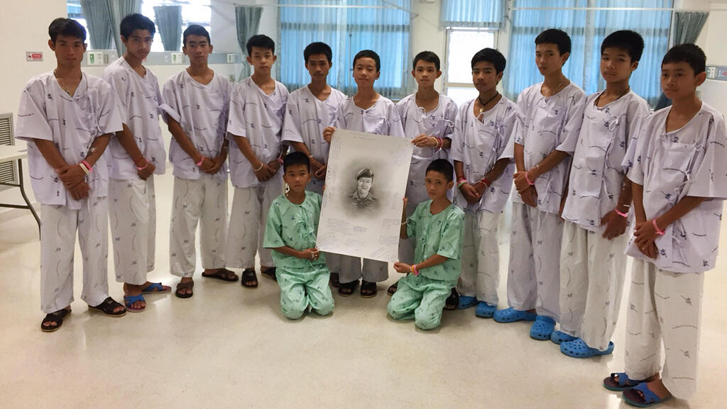 Group of boys rescued from a cave in Thailand in 2018 (Photo: AFP) תאילנד נערים לכודים חילוץ טקס זיכרון כבוד צוללן שנהרג סמאן קונאן
